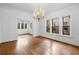 Elegant dining room featuring a stylish chandelier, hardwood floors, and bright, airy windows at 1095 Saint Charles Ne Pl, Atlanta, GA 30306