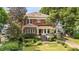 Beautiful home exterior featuring a porch swing and professionally landscaped yard at 1095 Saint Charles Ne Pl, Atlanta, GA 30306