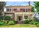 Charming two-story brick home featuring a welcoming front porch and well-manicured landscaping at 1095 Saint Charles Ne Pl, Atlanta, GA 30306