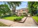 Beautiful two-story home featuring a brick driveway, well-kept lawn, and verdant shrubbery at 1095 Saint Charles Ne Pl, Atlanta, GA 30306