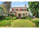 Charming two-story brick home with a welcoming front porch and lush, manicured landscaping at 1095 Saint Charles Ne Pl, Atlanta, GA 30306