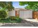 This garage features an exterior of white wood and brick with an asphalt driveway at 1095 Saint Charles Ne Pl, Atlanta, GA 30306