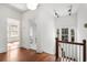 Hallway with wood floors, bright white trim, and staircase to upper levels at 1095 Saint Charles Ne Pl, Atlanta, GA 30306
