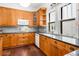 Traditional kitchen featuring wood cabinets, granite counters and modern appliances at 1095 Saint Charles Ne Pl, Atlanta, GA 30306