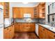 Spacious kitchen with wood cabinets, granite countertops, and stainless steel appliances at 1095 Saint Charles Ne Pl, Atlanta, GA 30306