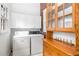 Functional laundry room with washer, dryer, and built-in wooden cabinets at 1095 Saint Charles Ne Pl, Atlanta, GA 30306