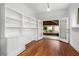 Bright living room with hardwood floors and built-in shelving, leading to screened porch at 1095 Saint Charles Ne Pl, Atlanta, GA 30306