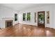 Cozy living room with hardwood floors, a fireplace, and ample natural light at 1095 Saint Charles Ne Pl, Atlanta, GA 30306