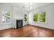 Bright living room with hardwood floors, a fireplace, and large windows at 1095 Saint Charles Ne Pl, Atlanta, GA 30306