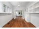 Bright living room featuring hardwood floors, large windows, and elegant built-in shelving at 1095 Saint Charles Ne Pl, Atlanta, GA 30306