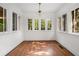 Bright sun room with hardwood floors and an abundance of natural light from the surrounding windows at 1095 Saint Charles Ne Pl, Atlanta, GA 30306