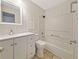 Well-lit bathroom with a single sink vanity and a shower-tub combo with white tiled walls at 1212 Utoy Springs Rd # 46, Atlanta, GA 30331