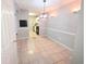 Light and bright dining area leading to a kitchen, complemented by tile flooring and modern lighting fixtures at 1212 Utoy Springs Rd # 46, Atlanta, GA 30331