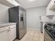 Well-lit kitchen featuring stainless steel refrigerator and tiled floors at 1212 Utoy Springs Rd # 46, Atlanta, GA 30331