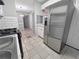 Bright kitchen with a stainless steel refrigerator and a tiled floor at 1212 Utoy Springs Rd # 46, Atlanta, GA 30331