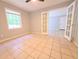 Empty living room featuring tile flooring, neutral paint, and french doors leading to other rooms at 1212 Utoy Springs Rd # 46, Atlanta, GA 30331