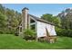 Exterior view of a home featuring a stone chimney and a lush green lawn at 2003 Greeson Rd, Dacula, GA 30019