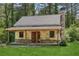 Charming home featuring a stone chimney, covered porch, and lush green lawn at 2003 Greeson Rd, Dacula, GA 30019