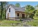 New home under construction with stone and siding, covered porch and stone chimney surrounded by trees and lawn at 2003 Greeson Rd, Dacula, GA 30019