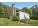 Side angle view of a charming home featuring stone accents and a large chimney at 2003 Greeson Rd, Dacula, GA 30019