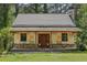 New home under construction with stone and siding, covered porch and stone chimney, surrounded by trees and green lawn at 2003 Greeson Rd, Dacula, GA 30019