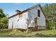 Exterior view showcasing the home's stonework and unfinished siding at 2003 Greeson Rd, Dacula, GA 30019