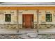 Stone and wood porch with new door and Tyvek home wrap above the stonework at 2003 Greeson Rd, Dacula, GA 30019