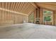 Unfinished living room featuring wood framework, fireplace, sink, with multiple windows for ample natural light at 2003 Greeson Rd, Dacula, GA 30019