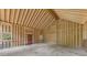 Spacious room under construction featuring vaulted ceilings, big windows and a red entry door at 2003 Greeson Rd, Dacula, GA 30019