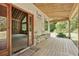 View of porch with wooden floors and vaulted ceiling with access to main house at 2003 Greeson Rd, Dacula, GA 30019