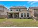Backyard view featuring a covered patio and green lawn at 2320 Ivy Birch Ln, Buford, GA 30519