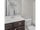 Neat bathroom featuring dark wood vanity with white countertop and sink at 2320 Ivy Birch Ln, Buford, GA 30519