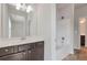 Bathroom features a dark vanity with a shower and toilet nearby at 2320 Ivy Birch Ln, Buford, GA 30519
