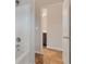Bathroom featuring a white tub, brushed hardware, and warm colored flooring at 2320 Ivy Birch Ln, Buford, GA 30519