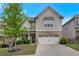 Beautiful two-story home with a stone and shingle exterior, lush landscaping, and a two-car garage at 2320 Ivy Birch Ln, Buford, GA 30519