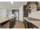Modern kitchen with stainless steel appliances, dark cabinets and granite countertops at 2320 Ivy Birch Ln, Buford, GA 30519