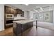 Bright kitchen boasting stainless appliances, dark cabinets, and large island at 2320 Ivy Birch Ln, Buford, GA 30519