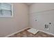 Laundry room with warm colored flooring, window, and utility connections at 2320 Ivy Birch Ln, Buford, GA 30519