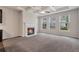 Open-concept living room features coffered ceilings, fireplace, and abundant natural light at 2320 Ivy Birch Ln, Buford, GA 30519