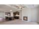 Open concept living features fireplace, kitchen with stainless appliances and dark cabinets at 2320 Ivy Birch Ln, Buford, GA 30519
