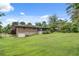 Large grassy backyard featuring a brick house with an attached garage and a screened-in sunroom at 2653 Elkhart Sw Cir, Marietta, GA 30064