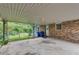 Covered patio area with brick siding, and door leading to the backyard space at 2653 Elkhart Sw Cir, Marietta, GA 30064