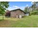 Brick home featuring an attached garage, a fenced yard, and an enclosed sunroom, set on a spacious lawn at 2653 Elkhart Sw Cir, Marietta, GA 30064