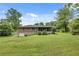 Spacious backyard featuring a well-maintained lawn and a charming brick house with an enclosed sunroom at 2653 Elkhart Sw Cir, Marietta, GA 30064