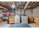 Basement laundry area includes washer, dryer, and storage, ready for finishing at 2653 Elkhart Sw Cir, Marietta, GA 30064