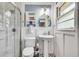 Stylish bathroom with a modern pedestal sink, tiled floors, and glass-enclosed shower at 2653 Elkhart Sw Cir, Marietta, GA 30064