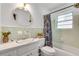 Fresh bathroom with mint tiling, shower and tub combo, and bright natural light at 2653 Elkhart Sw Cir, Marietta, GA 30064