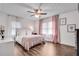 Cozy bedroom showcasing hardwood floors, natural light, a ceiling fan, and tasteful decor at 2653 Elkhart Sw Cir, Marietta, GA 30064