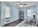 Well-lit room features wood floors, modern fan and fixtures, and built-in bookcase at 2653 Elkhart Sw Cir, Marietta, GA 30064