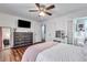 This bedroom features wood floors, natural light, ceiling fan, and adjacent bathroom at 2653 Elkhart Sw Cir, Marietta, GA 30064